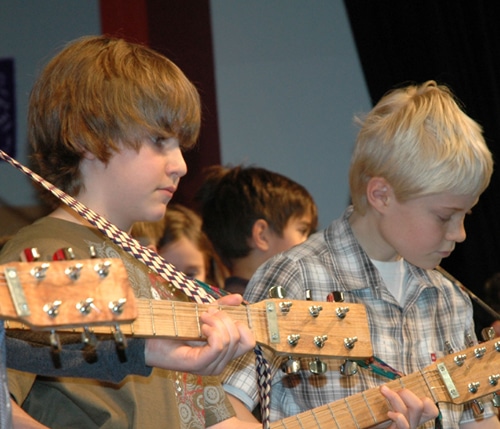 Students practicing on acoustic guitars