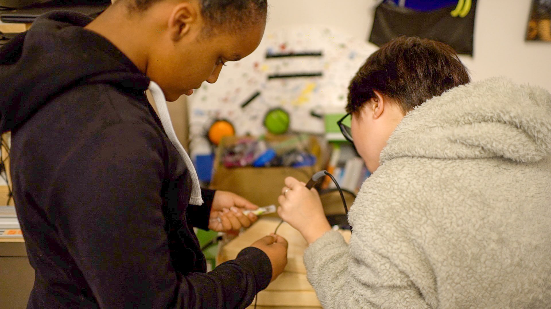 Two students soldering