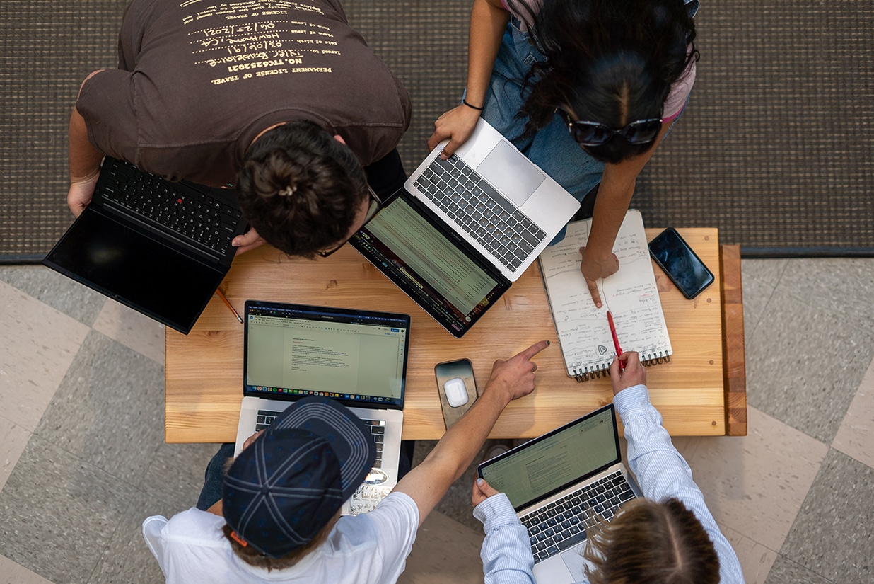 Students working together using their laptops