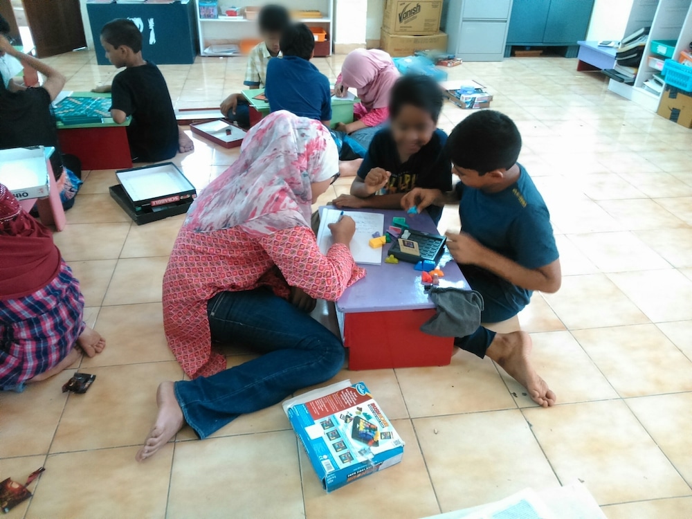 Kids playing a board game in a classroom