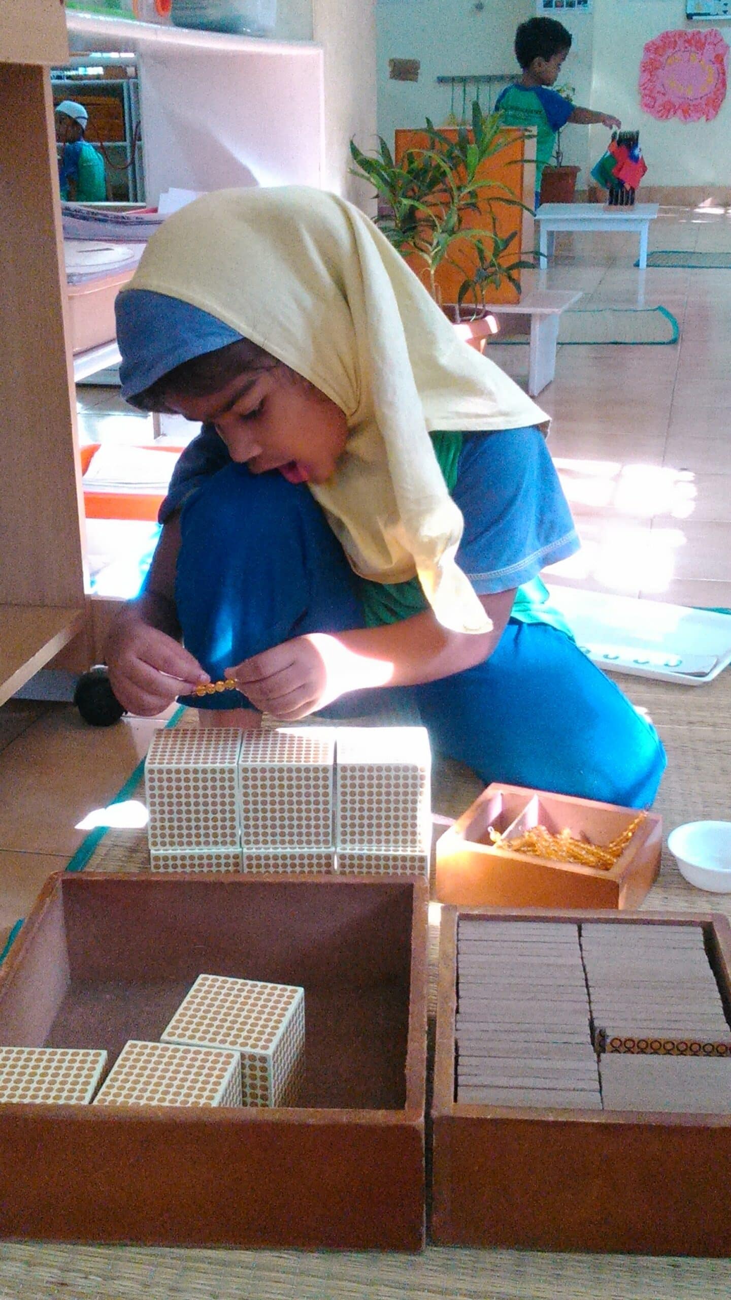 Student works with Montessori counting blocks