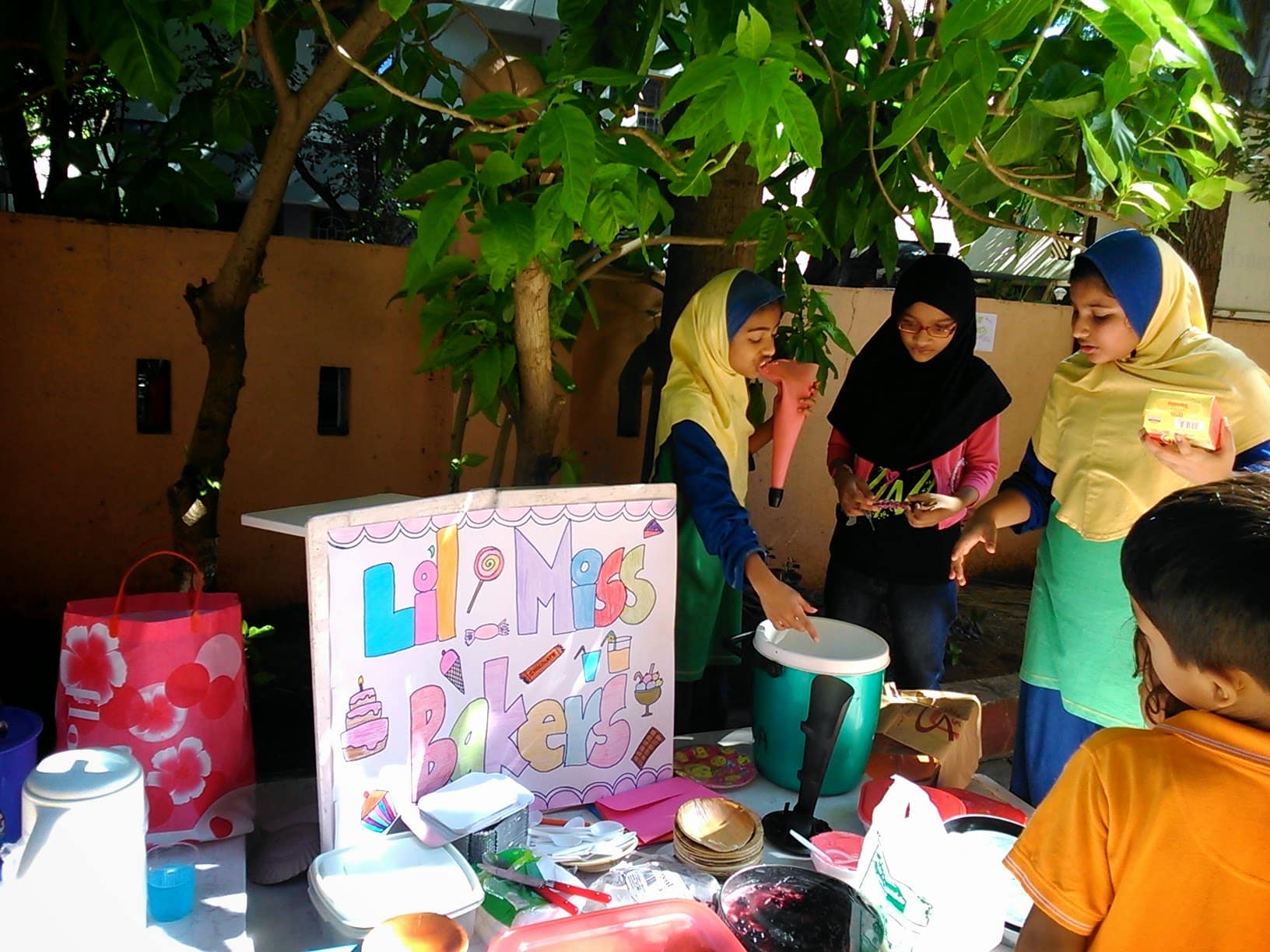 Kids selling muffins at a stand