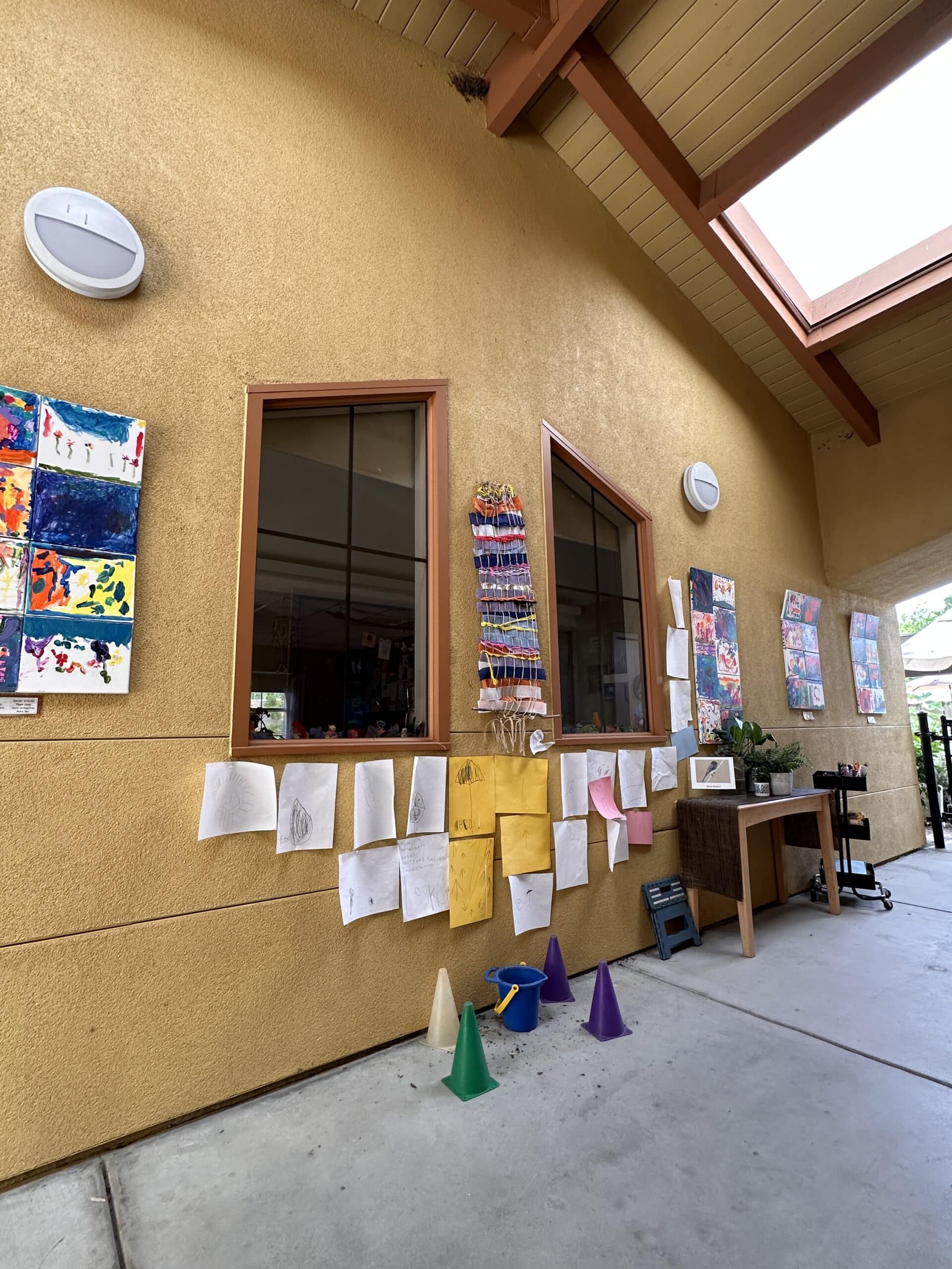 hallway outside classroom with bird's nest near roof