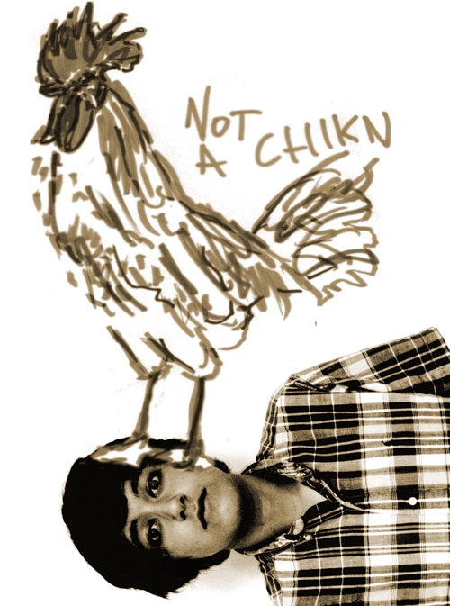 A person wearing a plaid shirt looks at the camera while standing beneath a large, hand-drawn rooster labeled Not a Chiikn on a white background. The drawing is stylized and playful.