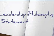 An open notebook displaying the handwritten text Leadership Philosophy Statement in blue ink. The page is blank except for the text, suggesting a focus on defining personal leadership principles.