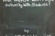 A chalkboard with the text What happens when police authority with students? written at the top. Below, it says by: followed by blurred, illegible writing. The board has a worn appearance.
