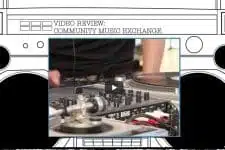 A close-up of a person using DJ equipment, with hands operating a turntable and mixer. The background features a sketch of a boombox. Text at the top reads Video Review: Community Music Exchange. A play button is overlayed on the image.