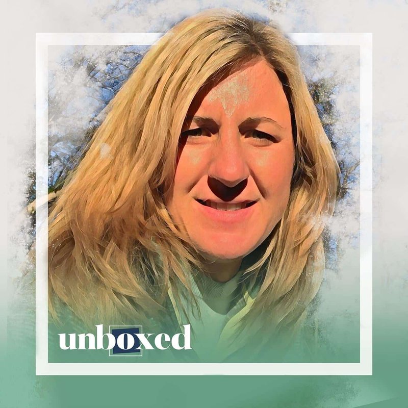 A woman with long blonde hair smiles against a blurred outdoor background, evoking the ethereal beauty of Cedarbrook. The image has a stylized, painterly effect reminiscent of Episode 3s unique aesthetic. The word unboxed elegantly appears in the bottom left corner.