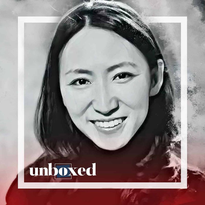 A black-and-white digital portrait of a woman smiling, encased in a white square frame. The word unboxed appears in the bottom left corner in white and blue text. Echoing the start of a new year at ETU School, the background features a textured grayscale gradient.