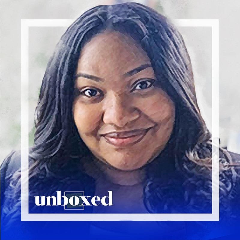 A woman with long dark hair is smiling, framed by a white square. The word unboxed in the bottom left corner over a blue gradient suggests her role in supporting change within complex systems.