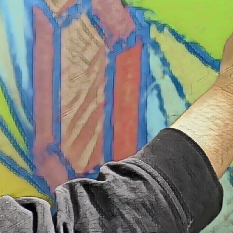 A person wearing a dark sleeve sketches a colorful geometric design reminiscent of stained glass on a light green background. The drawing features blue and red shapes with abstract elements, blending the charm of chalk art with vibrant creativity.