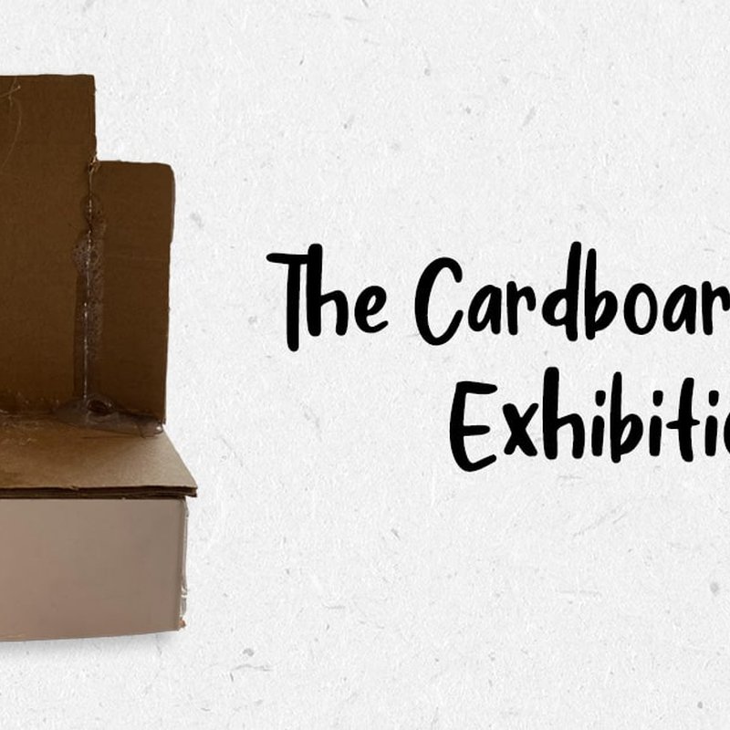 A piece of cardboard on the left with the text The Cardboard Exhibition on the right against a light background. The cardboard resembles a folded, upright piece from a Cardboard Chair exhibit.