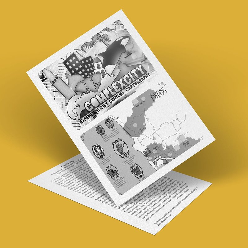 Two sheets of paper on a yellow surface, the top page displaying a grayscale complex city map titled ComplexCity: Internally Text Century Cartography with decorative elements and text.