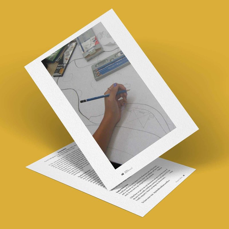 An image of a drawing in progress, featuring a persons hand using a pencil to sketch on paper. Various drawing tools and sketches are visible around the workspace. The background is a solid mustard yellow.