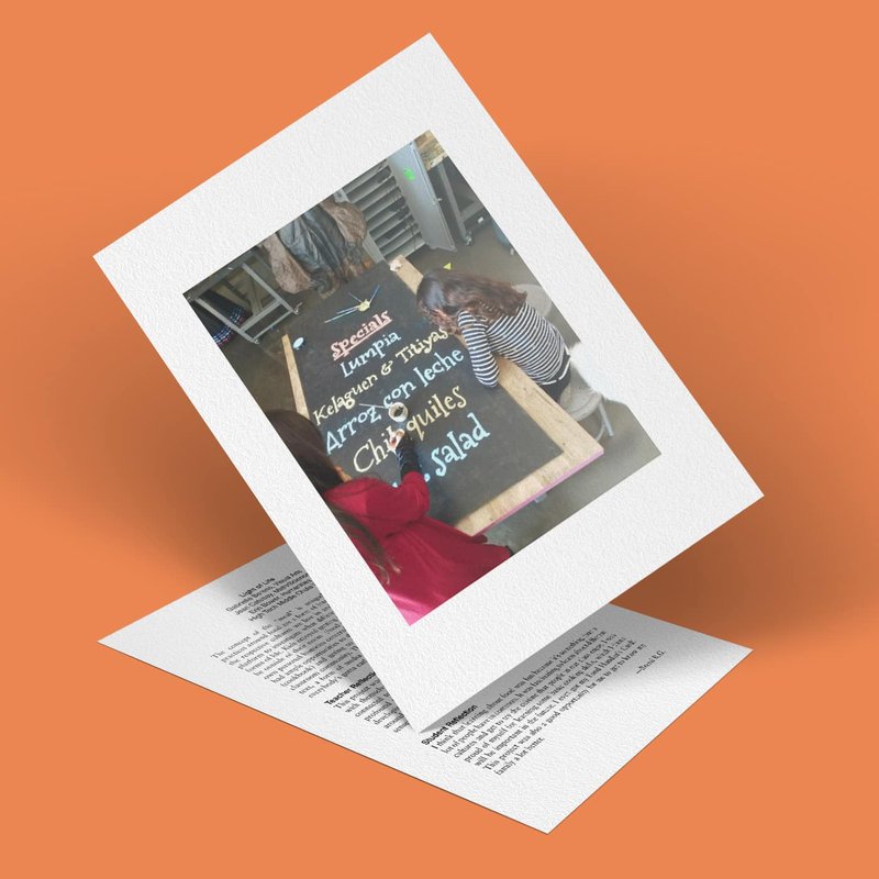 A photo of a menu handwritten on a chalkboard lying on a table. It lists specials including lumpia, kale and corn tostada, arroz con leche, chilaquiles, and salad. With an orange background adding life to the layered composition, this lively scene highlights culinary delights.