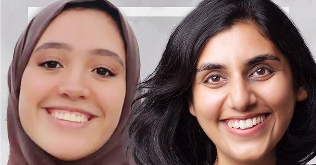 Two women are smiling warmly. The woman on the left, who might be a teacher, is wearing a hijab, while the woman on the right has shoulder-length hair. They seem to be enjoying a moment of connection, perhaps after solving an internet-related problem together against a neutral backdrop.