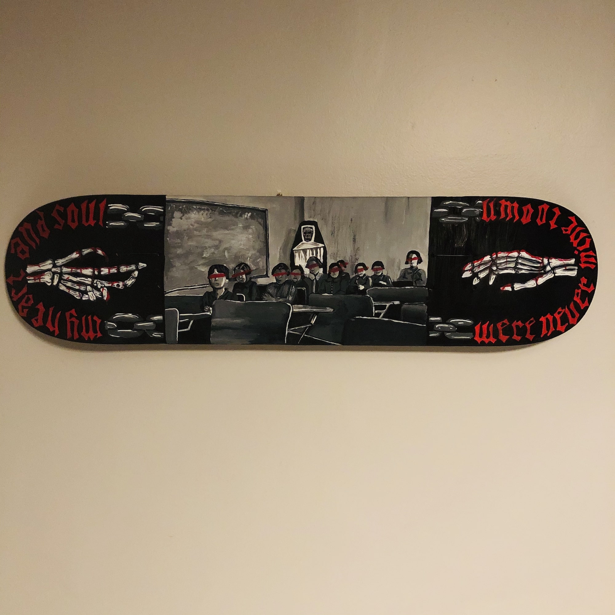 Skateboard deck showing an image of children in a residential school with red bars painted over their eyes, a skull-faced nun in the background.