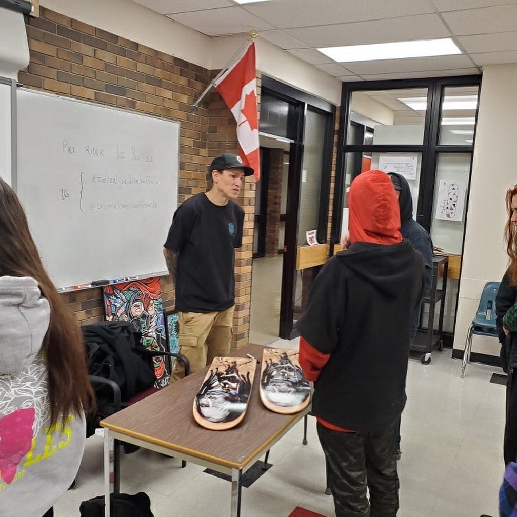 Pro Skater Joe Buffalo talks to students in classroom