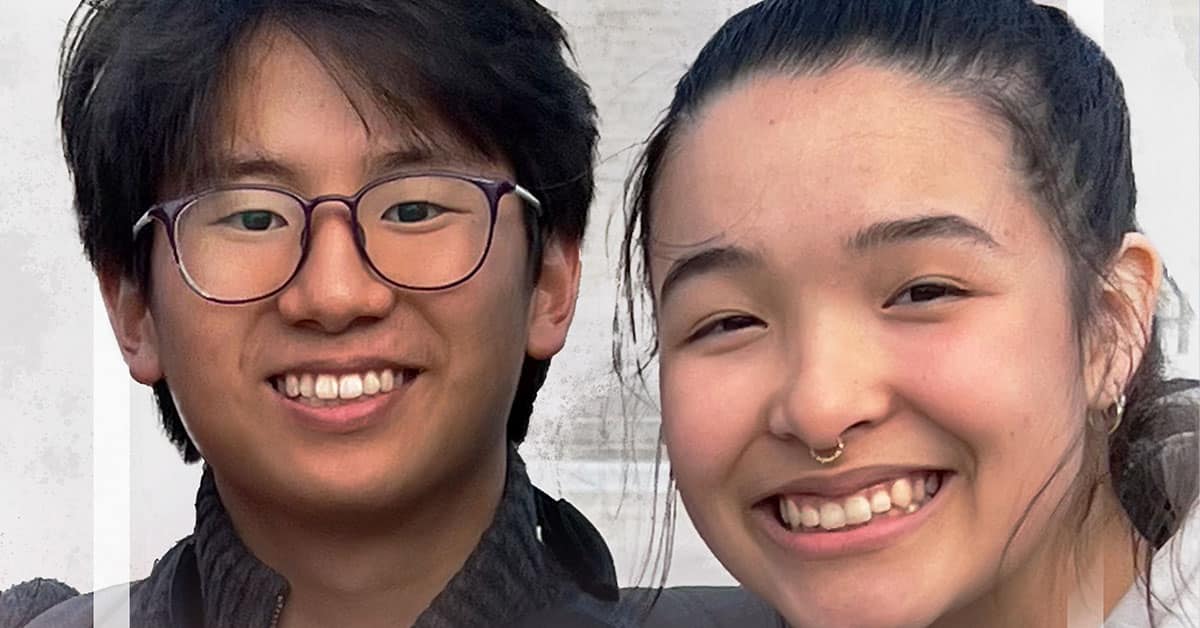A close-up of two students smiling at the camera. The student on the left is wearing glasses and a dark jacket. The one on the right, possibly from an Iowa high school, sports a nose ring and wears a dark top, embodying their own expression of free speech through style.