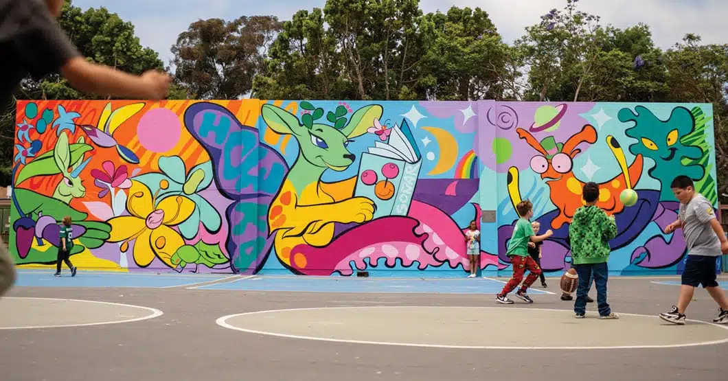 Kids playing in front of Scarlett Baily's mural at High Tech Elementary Explorer
