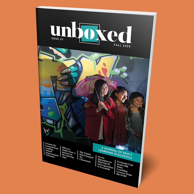 A journal cover titled “unboxed,” Issue 29, features three smiling women standing together, one holding a pink umbrella, in front of a colorful graffiti wall. The Fall 2025 issue spotlights adult learning in schools.