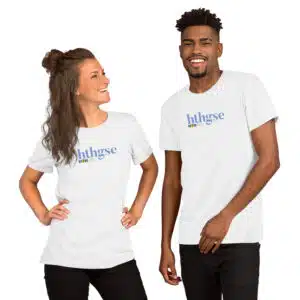A woman and a man stand side by side, smiling in matching unisex T-shirts with "hthgse IFTR" printed in full color blue and yellow text. The background is plain white.