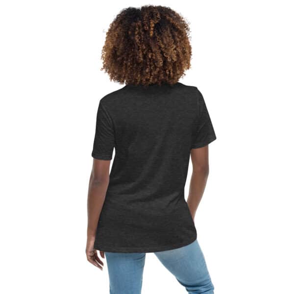 A person with curly hair stands with their back to the camera, wearing a Women's Relaxed Fit T-Shirt and light blue jeans against a plain white background.