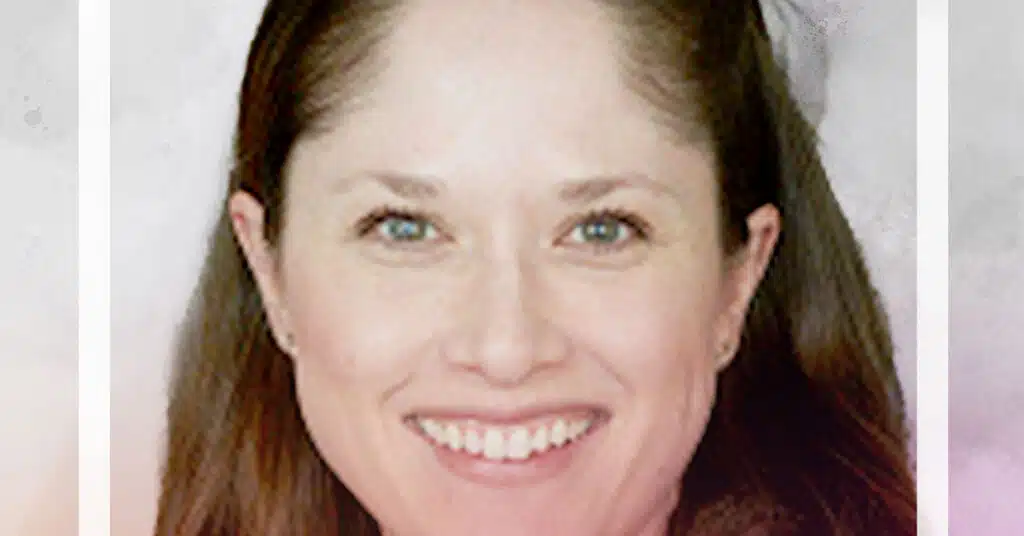 A woman with long brown hair smiles at the camera. She has light skin, blue eyes, and is wearing subtle makeup. The softly blurred background in neutral tones evokes a calm space to transform schools beyond bureaucracy. A white frame borders the image.