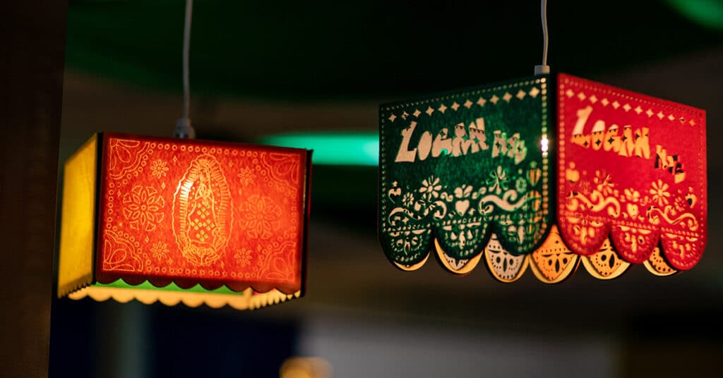 Two colorful, decorative hanging lamps are shown. The red lamp features a detailed design and artistic patterns, while the green and red lamp has scalloped edges and intricate patterns, offering inspiration for model critiques or instructional practice.