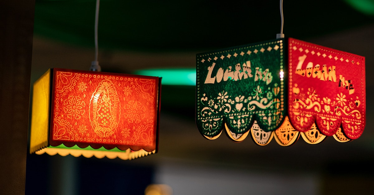 Two colorful, decorative hanging lamps are shown. The red lamp features a detailed design and artistic patterns, while the green and red lamp has scalloped edges and intricate patterns, offering inspiration for model critiques or instructional practice.
