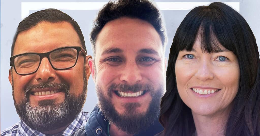 Three people smiling at the camera: a man with glasses and a beard, a man with a beard and curly hair, and a woman with long dark hair and blue eyes, all shown in close-up against a light background.