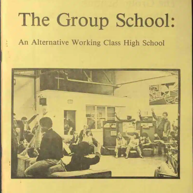 Yellowed 1981 book cover titled The Group School: An Alternative Working Class High School, featuring a black-and-white photo of students and a teacher in a classroom, several students raising their hands.